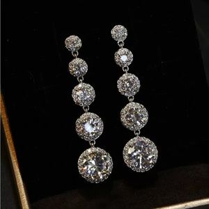 Hanging clear crystals in white metal